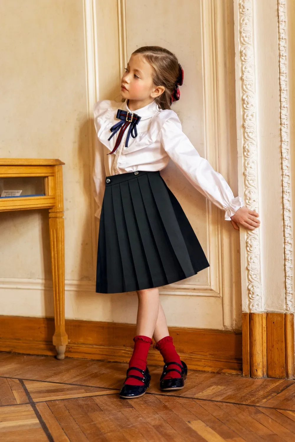 Black tartan pleated cotton skirt with gold buttons with coat of arms